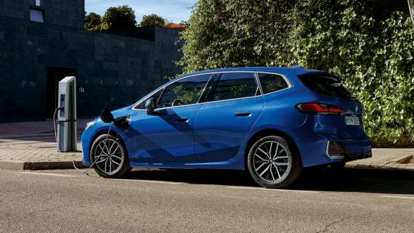 BMW 2 Series Active Tourer 230e plug-in hybrid U06 2021 M Portimao Blue metallic side view parking at charging station