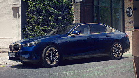 BMW 5 Series Sedan (G30) three-quarter side view driving 