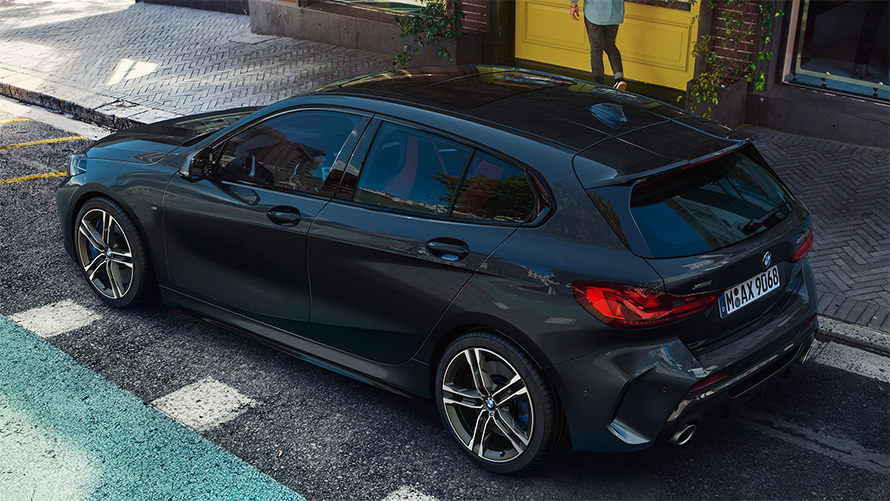 BMW M135i xDrive (F40) in Black Sapphire metallic parking, bird’s eye view of the side