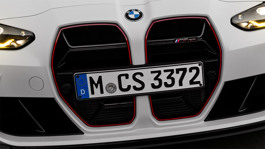 BMW M3 CS G80 CS specific kidney grille in black with red special model signature front view driving
