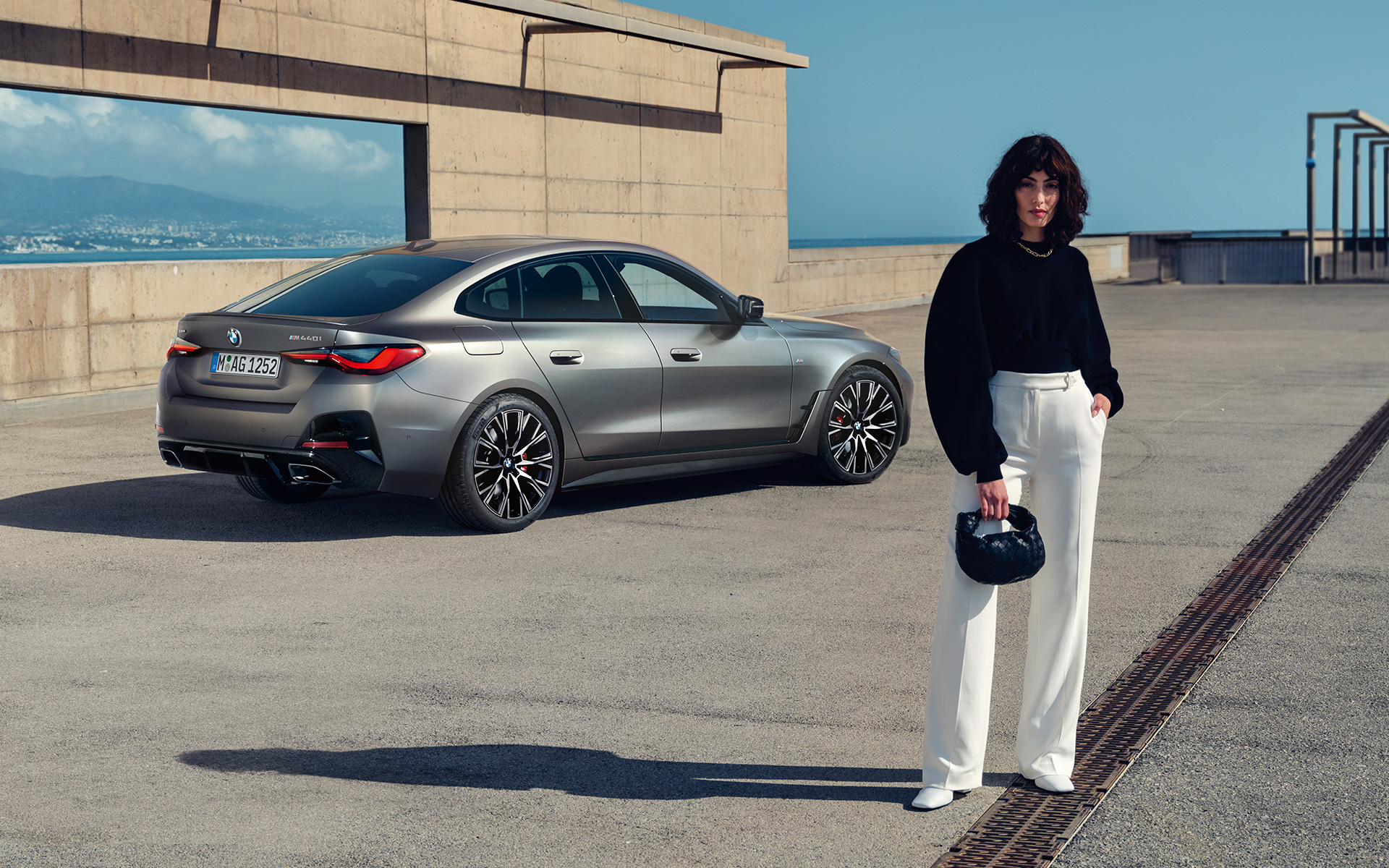 BMW M440i xDrive Gran Coupé G26 2021 Frozen Pure Grey metallic three-quarter rear view with model