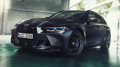 BMW M Series BMW M3 Competition Touring G81 three-quarter front view driving on the street