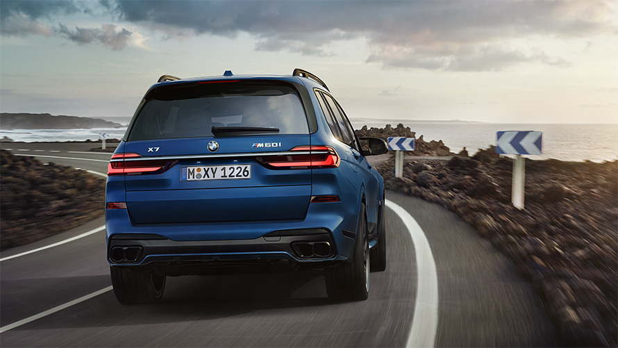 BMW X7 M60i xDrive G07 LCI Frozen Marina Bay Blue rear view driving