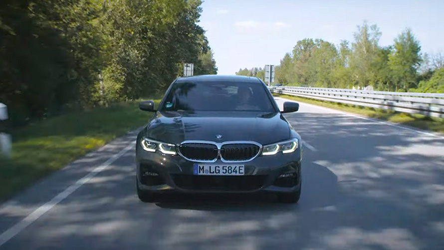 BMW G20 plug-in hybrid driving on the street front view