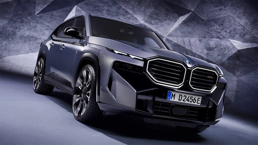 BMW XM G09 2022 BMW Individual Sepia metallic three-quarter front view standing in section